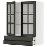 A modern black and white METOD kitchen cabinet with glass doors. It sleek design, beveled glass, and integrated shelving.