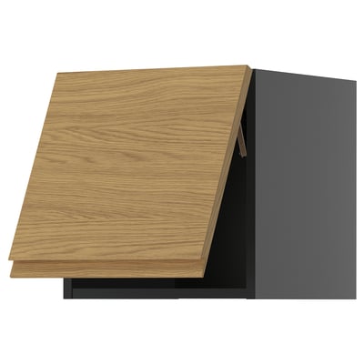 Modern kitchen cabinet in black with wooden-style drawer.