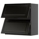 Black kitchen cabinet with two openable doors and bevelled edges.