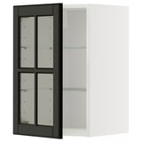 An ikea METOD kitchen cabinet with black bodbyn glass doors and a white frame. The cabinet has adjustable glass shelves and a modern design.