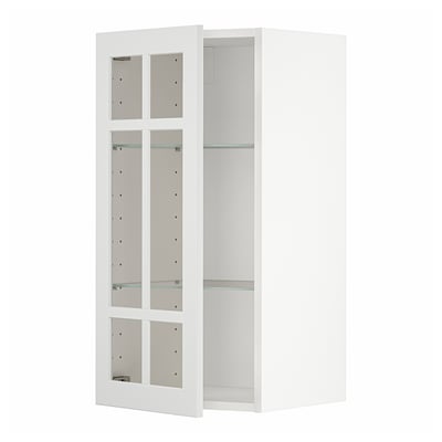 White METOD kitchen cabinet with glass doors and shelves.