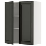 A black METOD kitchen wall cabinet with a bevelled edge door. Its rectangular, with two open doors revealing an adjustable shelf.