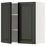 A black METOD kitchen wall cabinet with two doors open, revealing an adjustable shelf inside.