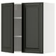 A black METOD kitchen wall cabinet with two doors open, revealing an adjustable shelf inside.