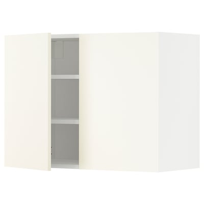 A white METOD kitchen cabinet with adjustable shelves and a door open, highlighting its internal storage.