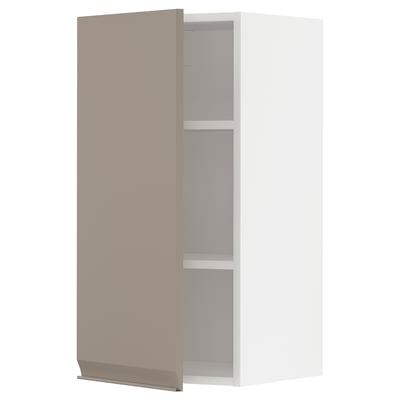 A modern, grey-beige kitchen cabinet with a matte finish and a slim handle. It has an adjustable shelf inside and a minimalist design.