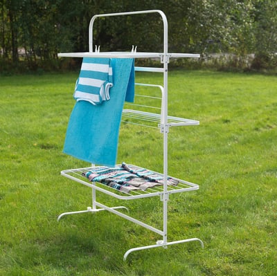 Clothes dryer rack outside with towels.