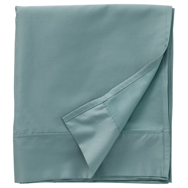 A neatly folded light blue-green NATTJASMIN sheet set, silky smooth with pleated edge design, made from 60% cotton and 40% lyocell.