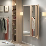 Modern bedroom with large NISSEDAL mirrors, wardrobe, and bed. Mirrors add luxury with wall art and pendant lamp.