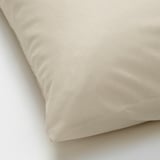 Beige pillowcase, smooth texture, high-quality cotton. Soft, natural fiber feel, neatly folded.