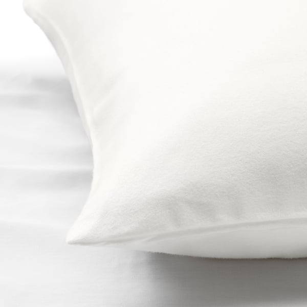 Soft, white, close-up of a flannel pillow and sheet set, showcasing smooth texture and quality.