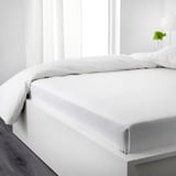 Crisp white bed with flannel sheets, soft and warm, perfect for cozy nights.