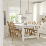 Extendable NORDVIKEN dining table with 8 chairs in bright kitchen.
