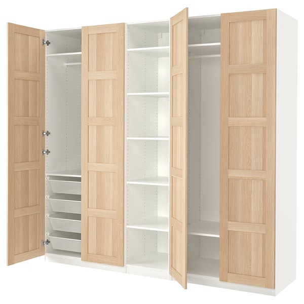 This image shows an ikea PAX wardrobe in white and light wood finish. It four open doors, two shelves, and pull-out mesh baskets.