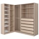 A light wood-colored PAX wardrobe unit with multiple shelves and drawers for storage.