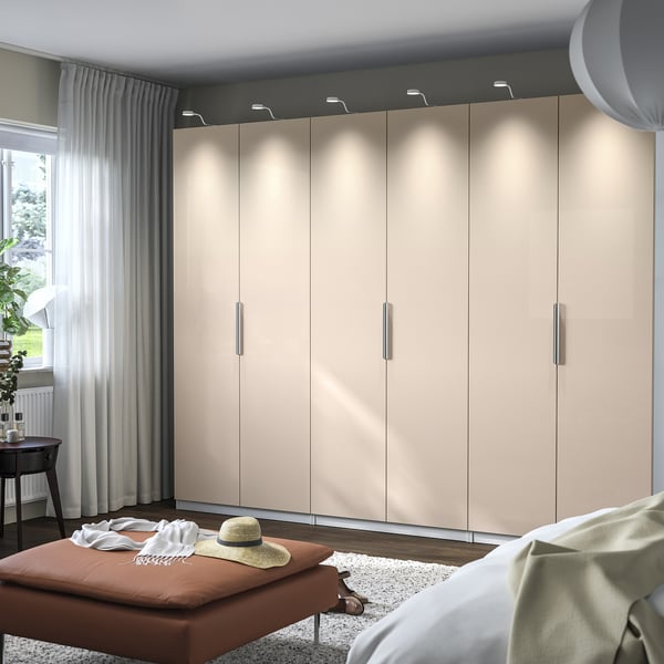 PAX wardrobe with lighting, bench, clothes, and bed