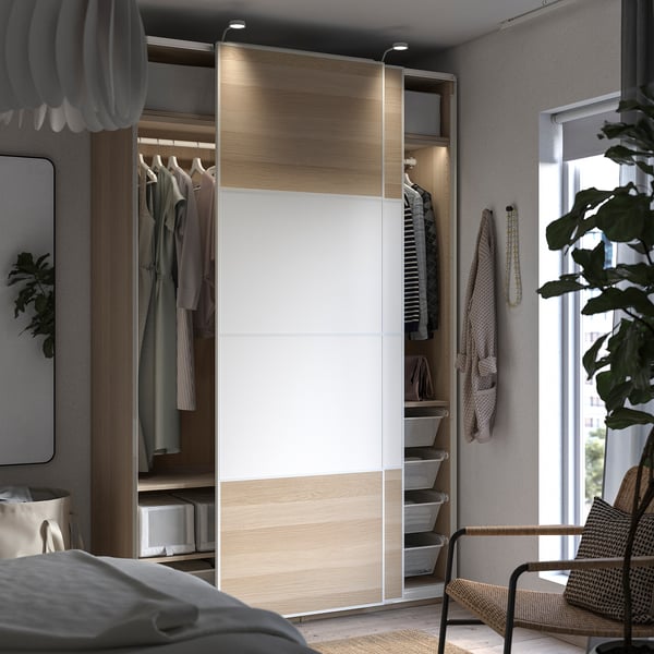 Modern bedroom with PAX wardrobe & wicker chair.