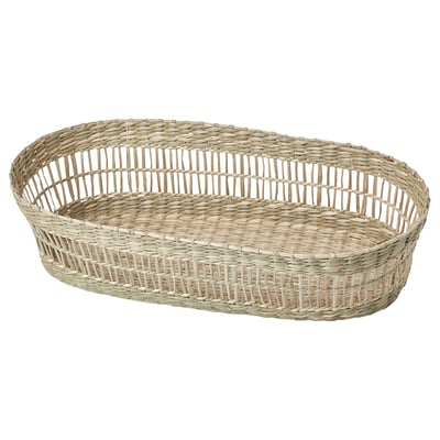 An oval-shaped wicker basket named PENNFISK, handwoven from natural sedge. Its ideal for storing cutlery with a rustic, earthy design.