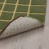 Checkered wool doormat with anti-slip backing, catching dirt efficiently.