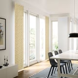 Modern dining area with PRÄRIEOXALIS curtains, black chairs, and striped rug.
