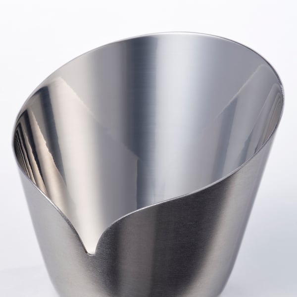 Stainless steel candle holder, sleek and polished inside, matte outside, resembling delicate flower petals.