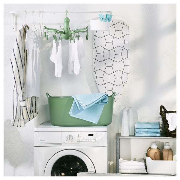 Laundry room with PRESSA dryer, washing machine, and organizers.