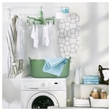 Laundry room with PRESSA dryer, washing machine, and organizers.