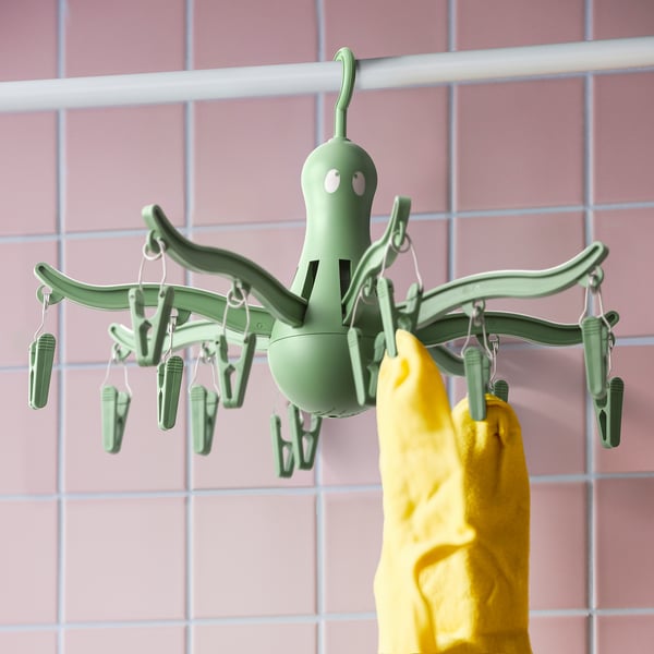A PRESSA hanging dryer with 16 pegs, holding yellow socks. Its designed for drying small items like socks and underwear.