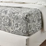 Bed flat sheet with paisley print, fine sheen, folded, showing thread tag.