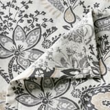 Elegant paisley-patterned bed sheet, soft cotton-viscose blend, intricate floral design, fine sheen, high-quality feel.