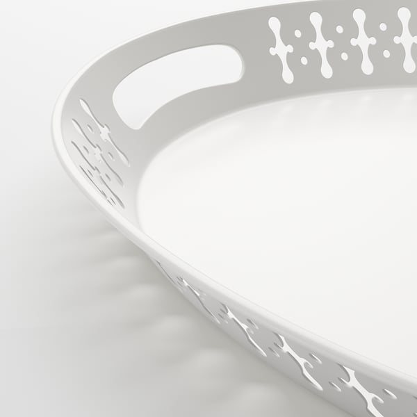 Circular white tray with cutout handles.
