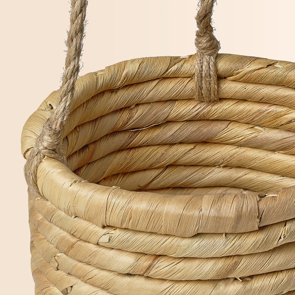 Handmade woven basket with sturdy jute handles, crafted from natural sedge and water hyacinth.