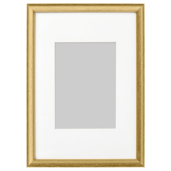 A gold picture frame with white mat, empty, standing upright.