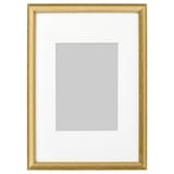 A gold picture frame with white mat, empty, standing upright.