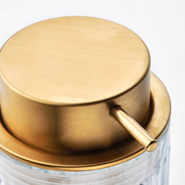 Gold-tinted soap dispenser top with handle on clear glass base. Modern design, high-quality materials.