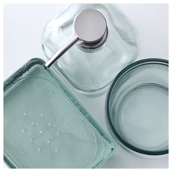 SKOGSFALK glass accessories: clear tray, round dish, soap dispenser with metal pump, elegantly designed.