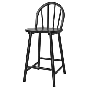 A black SKOGSTA barstool with an arched back, four wooden legs, and a round seat.