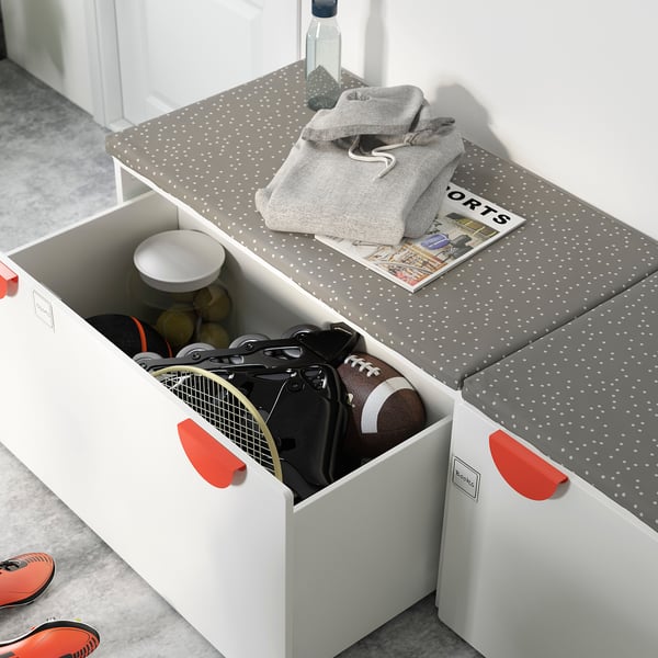 White SMÅSTAD box with red handles holds sports equipment.