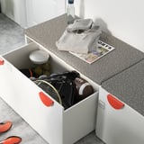 White SMÅSTAD box with red handles holds sports equipment.