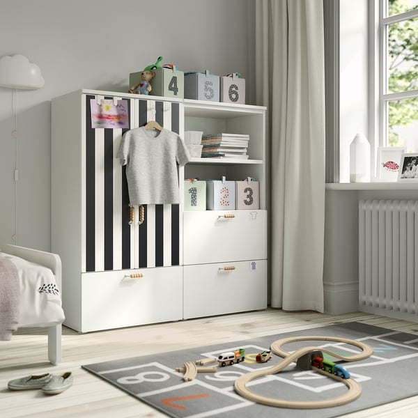Striped SMÅSTAD wardrobe with storage boxes, shirt, drawers, and train play mat.