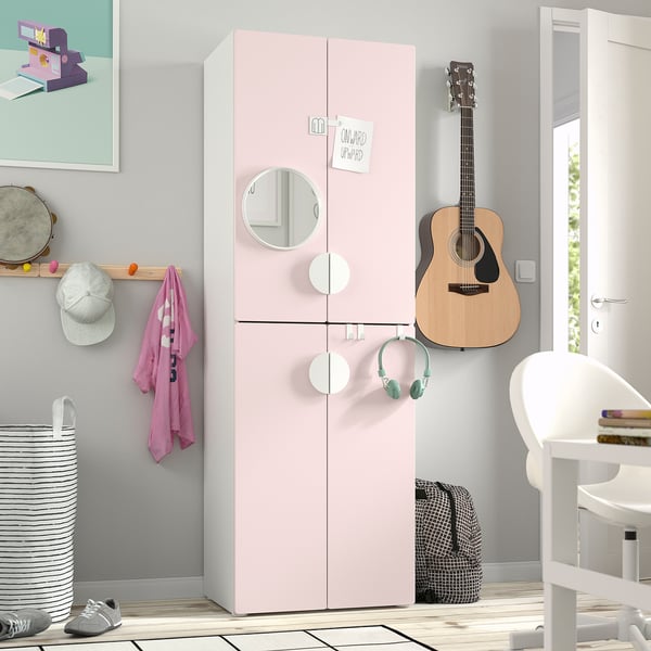 Pink SMÅSTAD wardrobe with mirror, guitar, & headphones, small room.