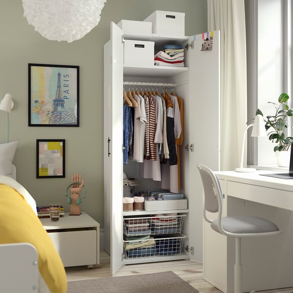 Open wardrobe displaying clothes, with storage boxes and shelves.