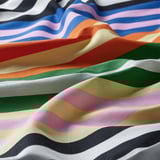 Close-up of vibrant, multicolored striped fabric, smooth and wrinkle-resistant, showcasing quality cotton/viscose blend.