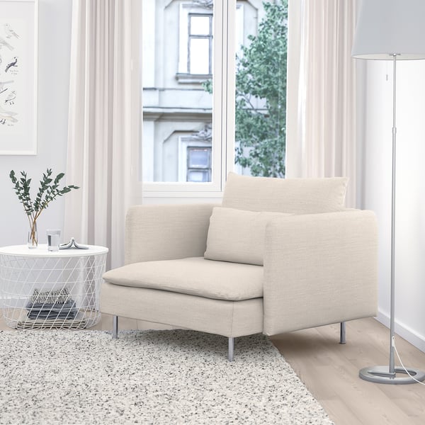 Modern beige SÖDERHAMN chair, sleek & cosy, fits snugly by large window.