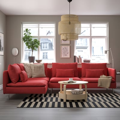 Modern red l-shaped SÖDERHAMN sofa, striped rug, black & white. Soft fabric, big windows, plush cushions.
