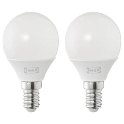 Two ikea led light bulbs, round and white, made of plastic.