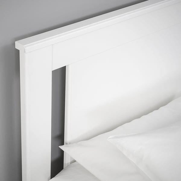 Crisp white bed frame with clean lines, featuring a hidden storage compartment.