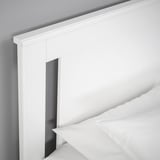 Crisp white bed frame with clean lines, featuring a hidden storage compartment.