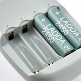 Rechargeable batteries in quality charger. Four green batteries labeled ladda 2450 in slots.