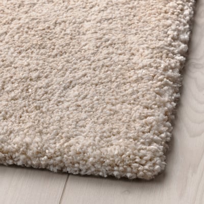 STOENSE beige soft rug, dense pile, rectangular shape, made from synthetic rubber and recycled polyester.